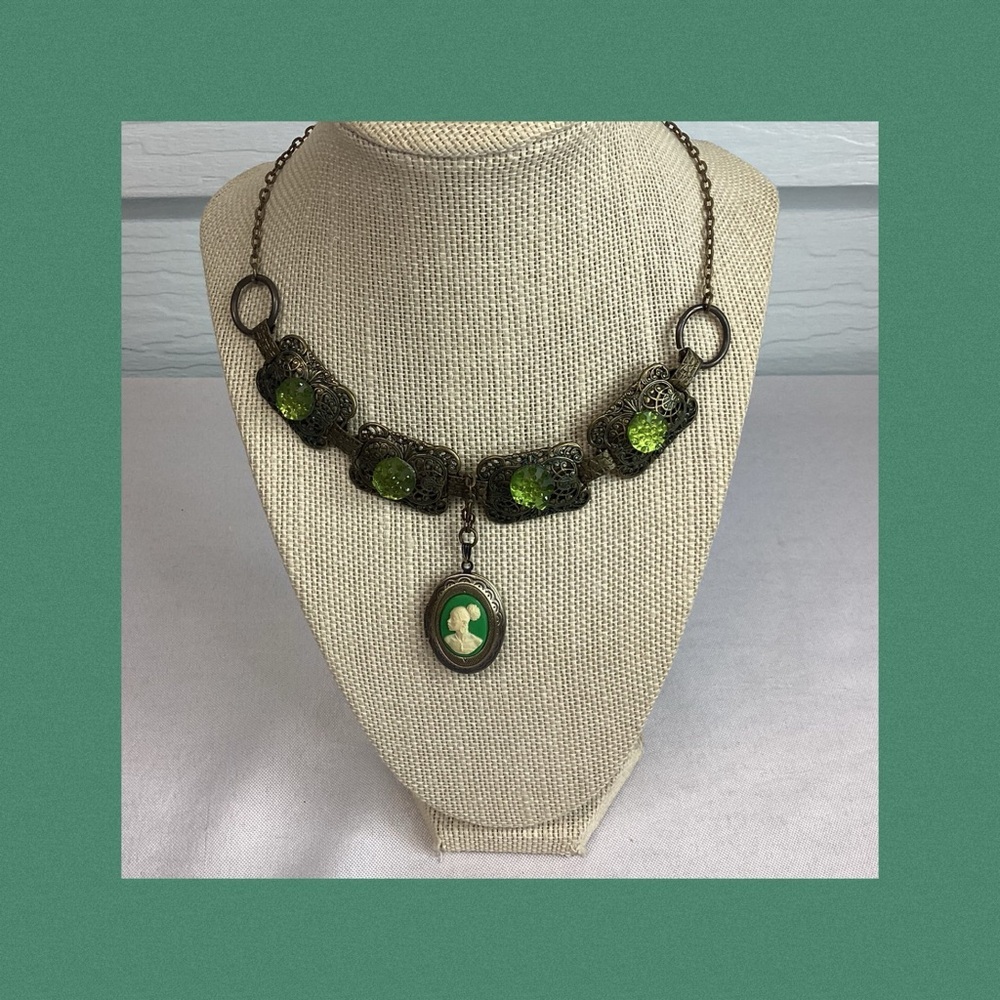 Green and bronze necklace with locket.